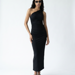 Woman wearing a black one-shoulder dress on a white background