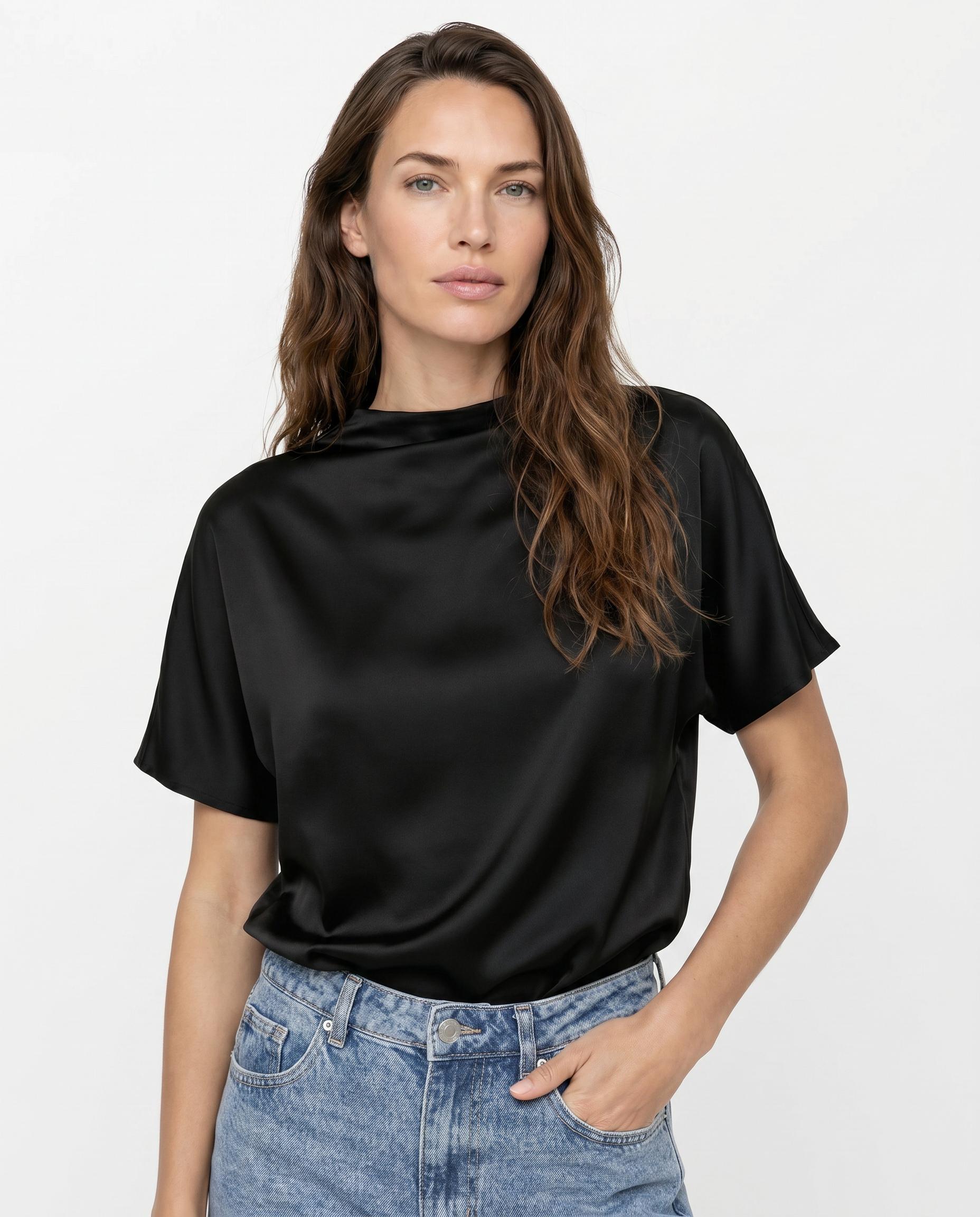 Woman wearing a black t-shirt and blue jeans on a white background